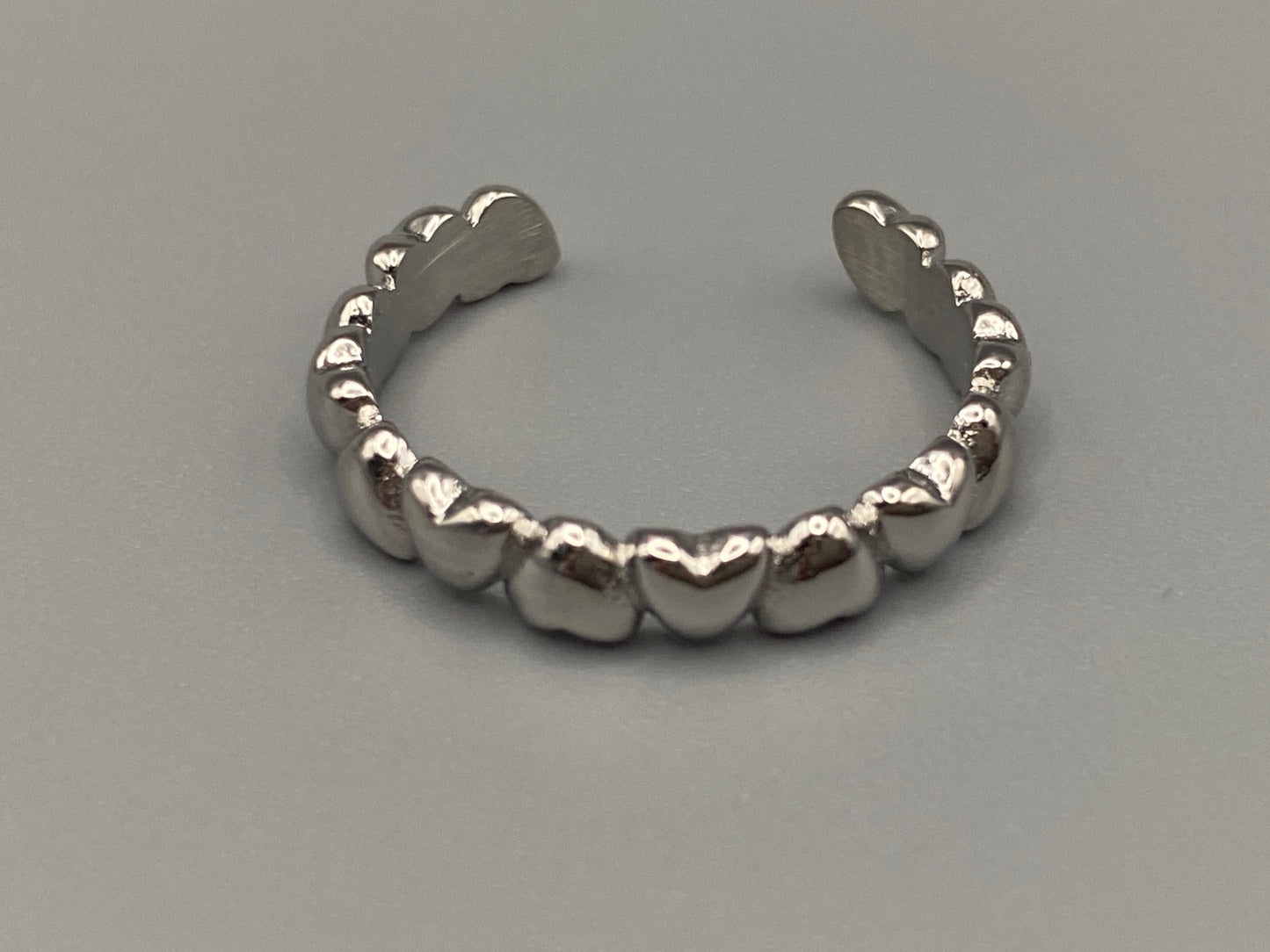Bianca Stainless Steel Ring: Crafted from high-quality 316L stainless steel, this ring features a sleek, intertwined design that exudes sophistication. Available in size 7, it combines durability with a trendy, elegant pattern.