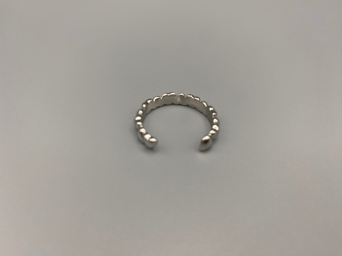Bianca Stainless Steel Ring: Crafted from high-quality 316L stainless steel, this ring features a sleek, intertwined design that exudes sophistication. Available in size 7, it combines durability with a trendy, elegant pattern.