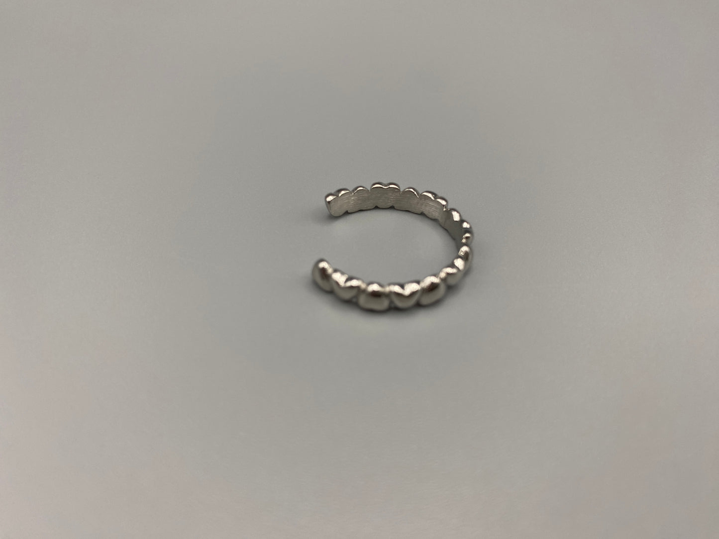 Bianca Stainless Steel Ring: Crafted from high-quality 316L stainless steel, this ring features a sleek, intertwined design that exudes sophistication. Available in size 7, it combines durability with a trendy, elegant pattern.