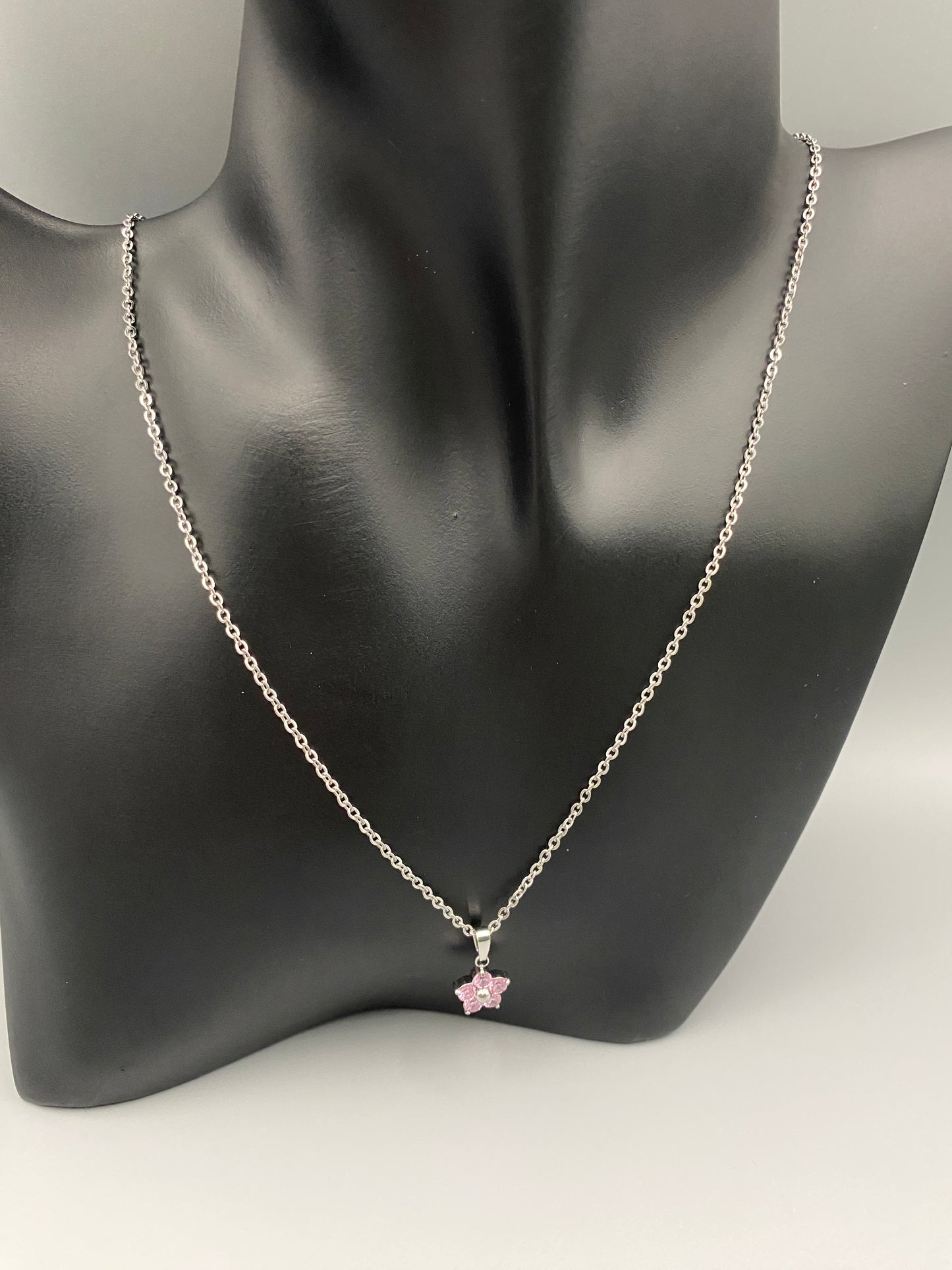 “Blossom Silver Pendant Necklace with a plum blossom design, featuring colourful cubic zirconia stones in a claw setting. Made from durable stainless steel with PVD plating. Measures 46 cm with a 5 cm adjustment.”