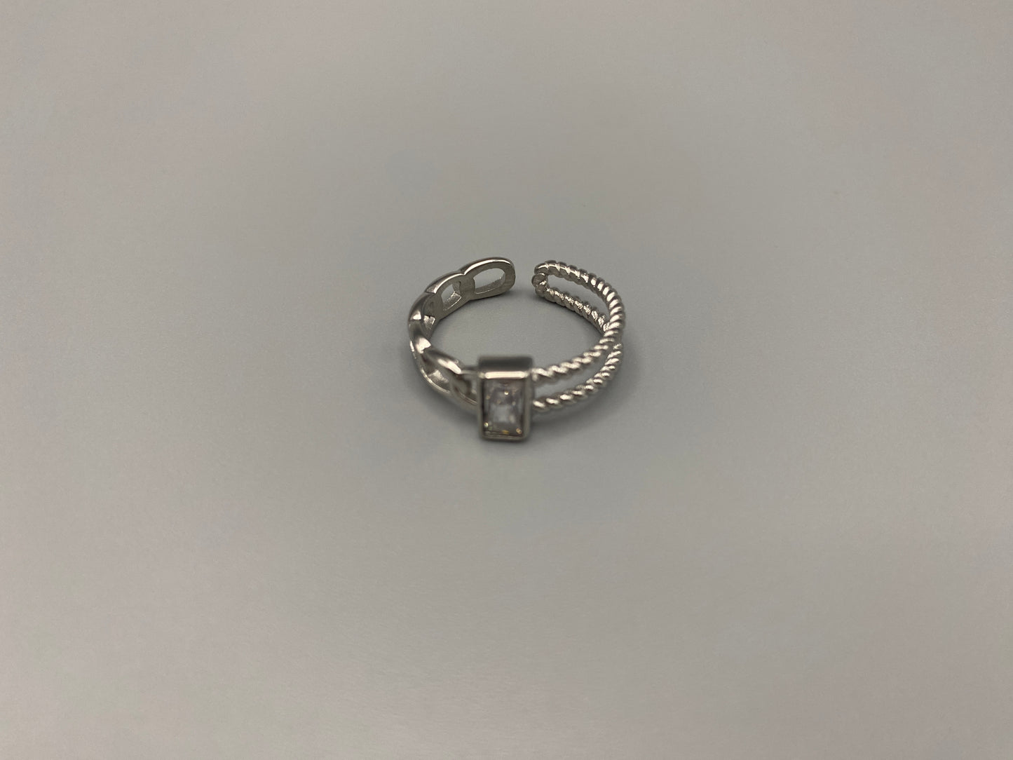 Breanna Adjustable Zirconia Ring: A stunning piece of jewellery that combines elegance and versatility. Made from high-quality 316L stainless steel, this ring features a sparkling zircon stone and an adjustable band for a perfect fit. The trendy design ensures it stands out, making it a must-have accessory.