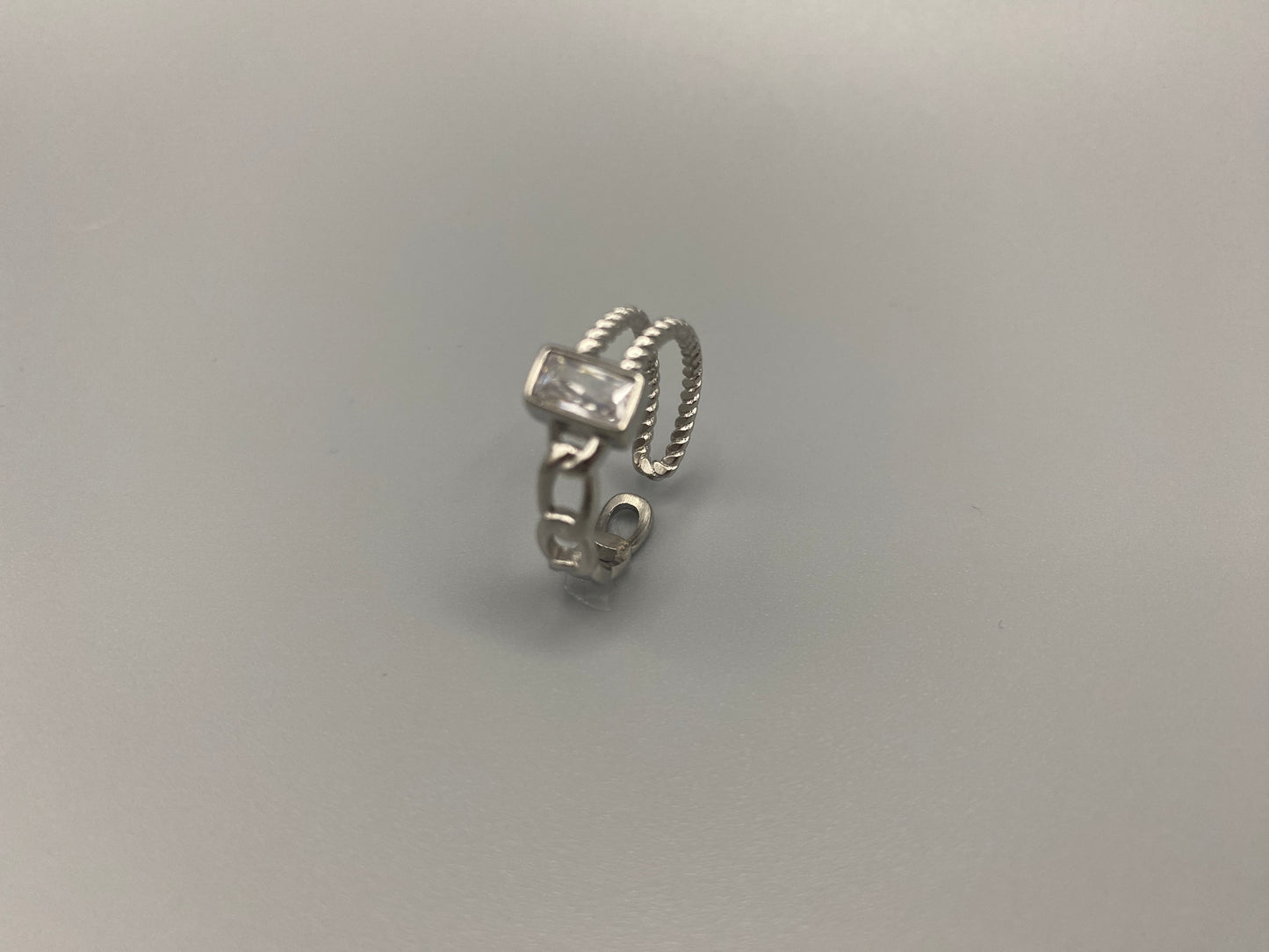 Breanna Adjustable Zirconia Ring: A stunning piece of jewellery that combines elegance and versatility. Made from high-quality 316L stainless steel, this ring features a sparkling zircon stone and an adjustable band for a perfect fit. The trendy design ensures it stands out, making it a must-have accessory.