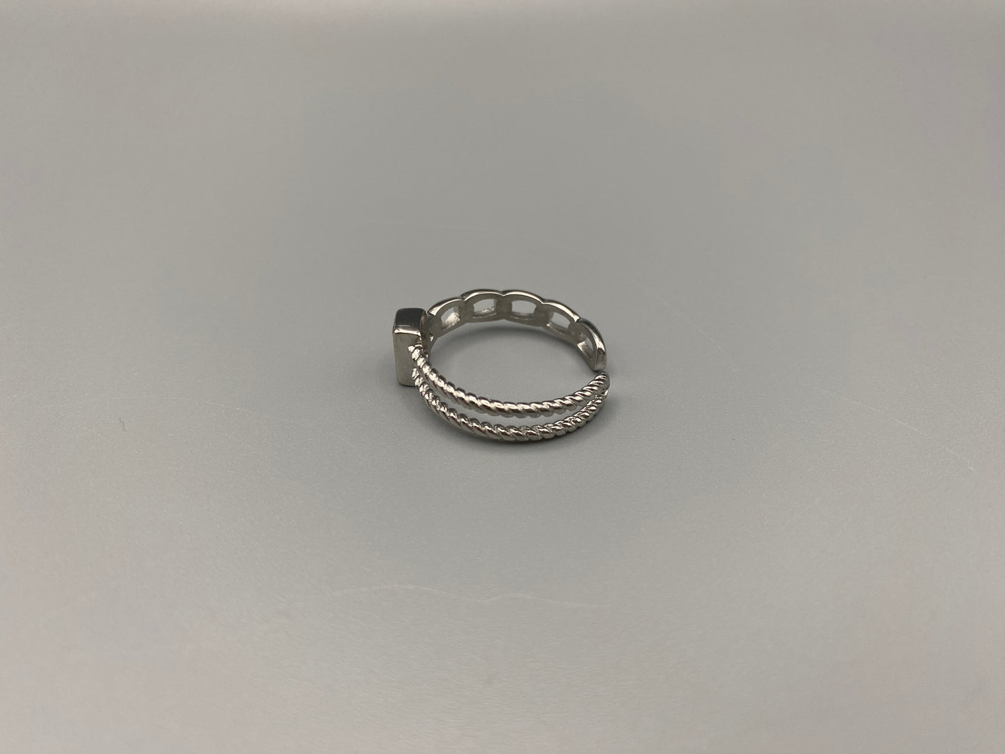 Breanna Adjustable Zirconia Ring: A stunning piece of jewellery that combines elegance and versatility. Made from high-quality 316L stainless steel, this ring features a sparkling zircon stone and an adjustable band for a perfect fit. The trendy design ensures it stands out, making it a must-have accessory.