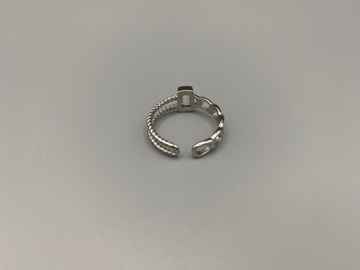 Breanna Adjustable Zirconia Ring: A stunning piece of jewellery that combines elegance and versatility. Made from high-quality 316L stainless steel, this ring features a sparkling zircon stone and an adjustable band for a perfect fit. The trendy design ensures it stands out, making it a must-have accessory.