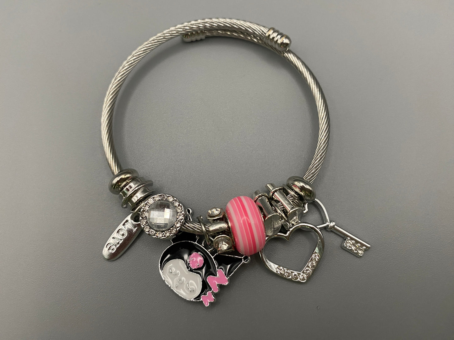 “Cartoon Character Bracelet in pink with a playful and stylish design, made from durable stainless steel, alloy charms, crystals, and glass beads. Adjustable 6cm diameter for a comfortable fit.”