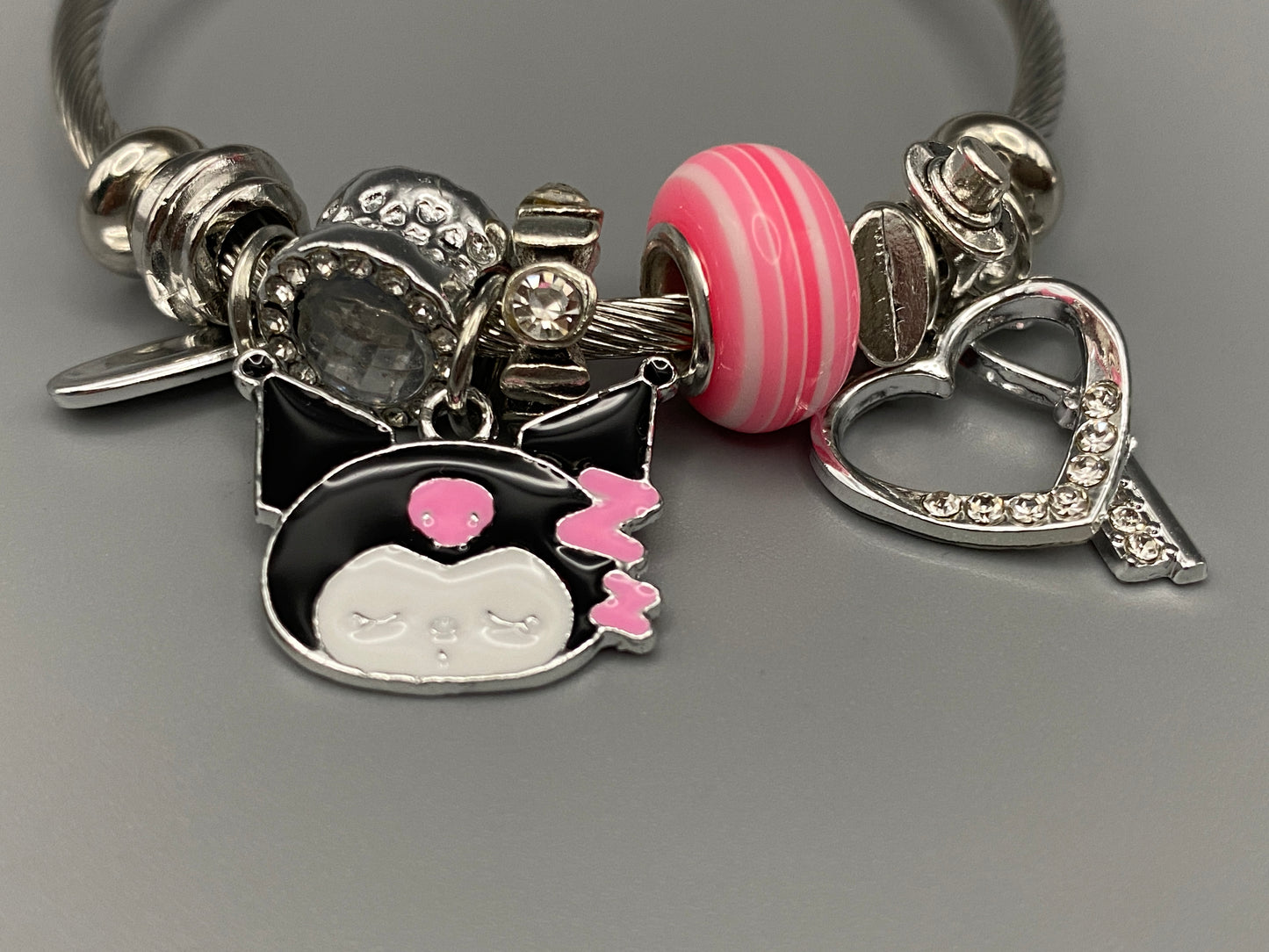 “Cartoon Character Bracelet in pink with a playful and stylish design, made from durable stainless steel, alloy charms, crystals, and glass beads. Adjustable 6cm diameter for a comfortable fit.”