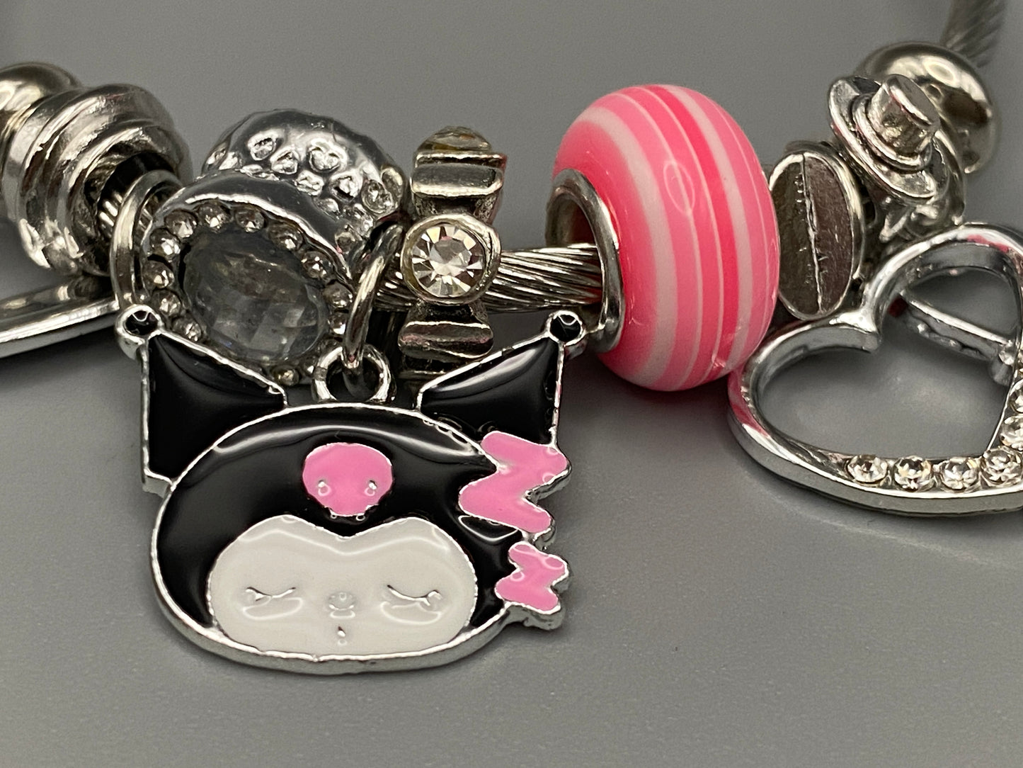 “Cartoon Character Bracelet in pink with a playful and stylish design, made from durable stainless steel, alloy charms, crystals, and glass beads. Adjustable 6cm diameter for a comfortable fit.”