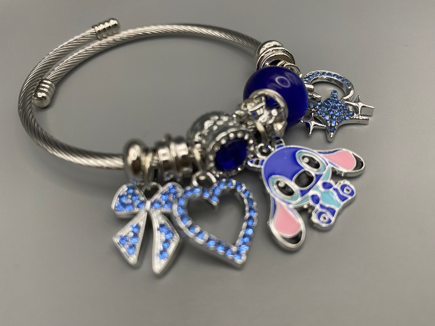 “Cartoon Character Bracelet in Blue with a playful and stylish design, made from durable stainless steel, alloy charms, crystals, and glass beads. Adjustable 6cm diameter for a comfortable fit.”