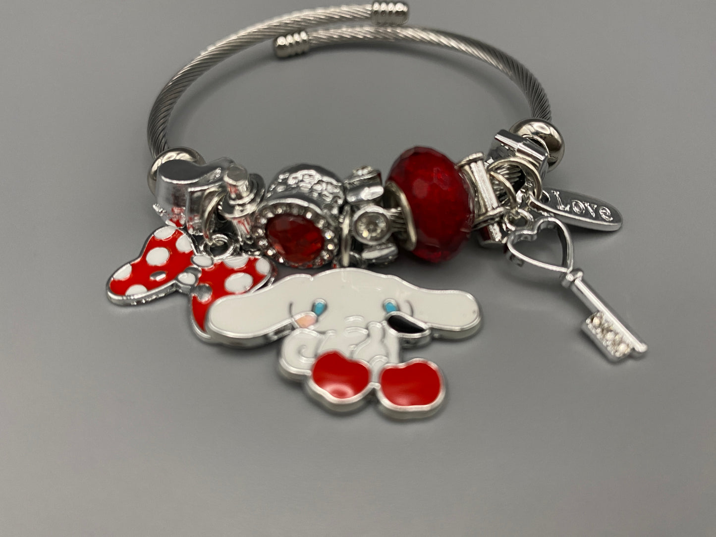 “Cartoon Character Bracelet in Red with a playful and stylish design, made from durable stainless steel, alloy charms, crystals, and glass beads. Adjustable 6cm diameter for a comfortable fit.”