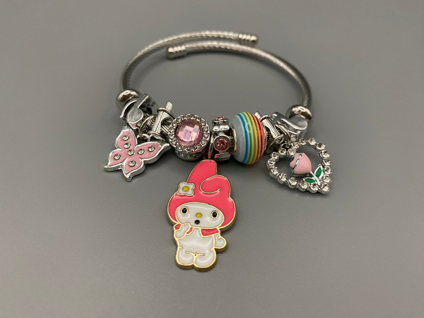“Cartoon Character Bracelet in Dark Pink with a playful and stylish design, made from durable stainless steel, alloy charms, crystals, and glass beads. Adjustable 6cm diameter for a comfortable fit.”