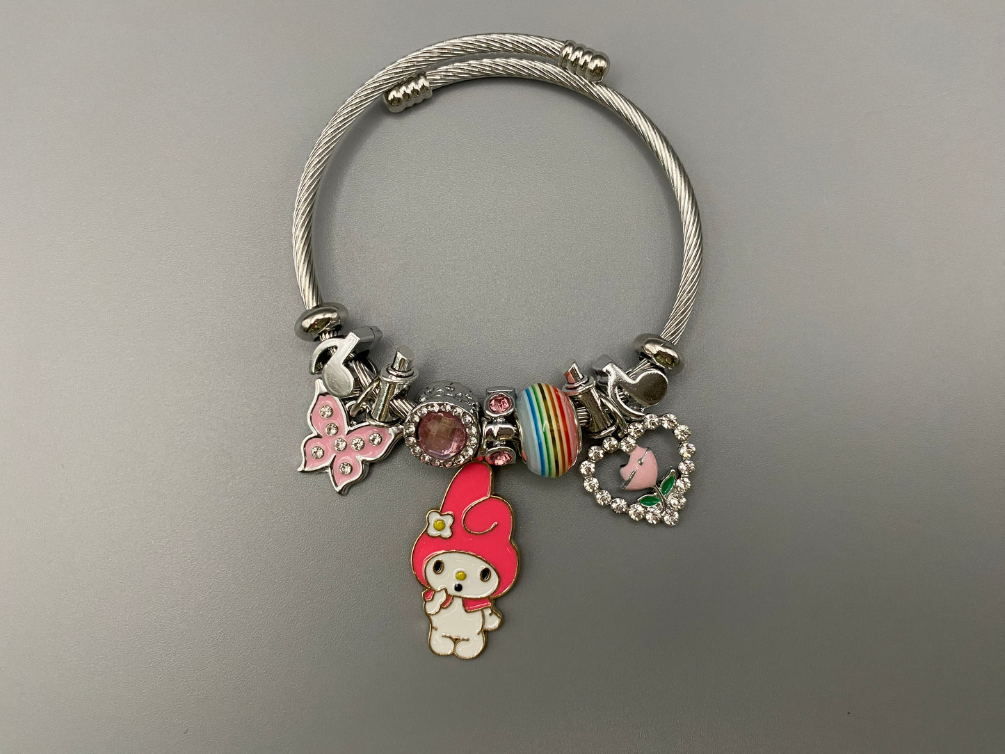 “Cartoon Character Bracelet in Dark Pink with a playful and stylish design, made from durable stainless steel, alloy charms, crystals, and glass beads. Adjustable 6cm diameter for a comfortable fit.”