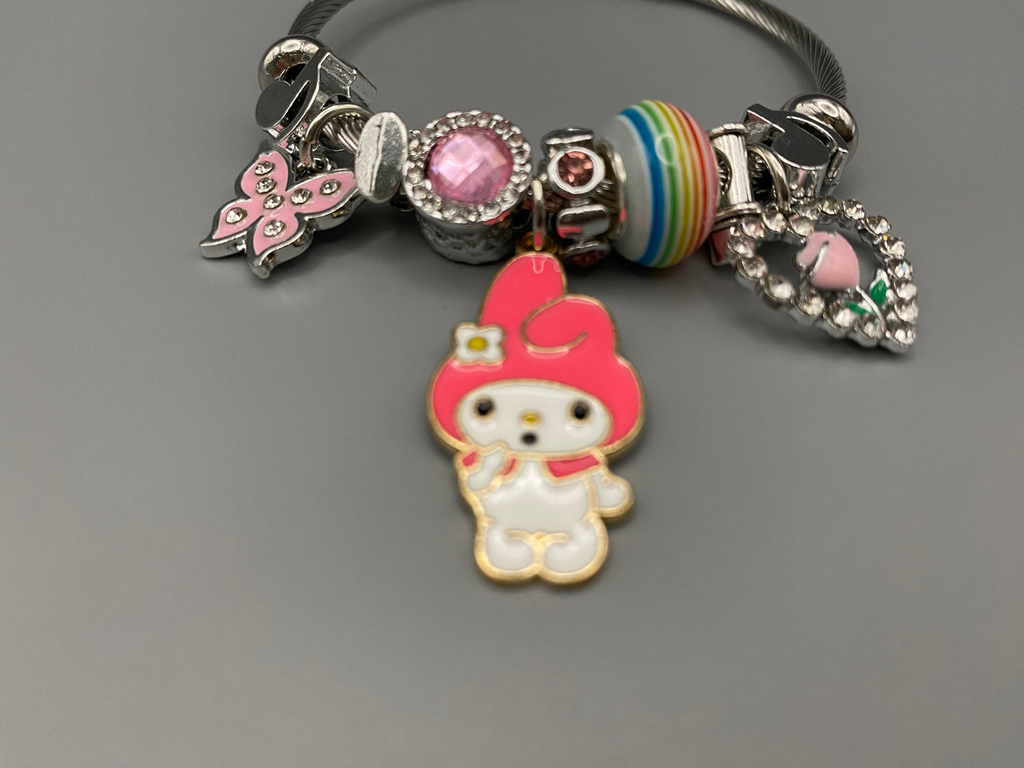 “Cartoon Character Bracelet in Dark Pink with a playful and stylish design, made from durable stainless steel, alloy charms, crystals, and glass beads. Adjustable 6cm diameter for a comfortable fit.”