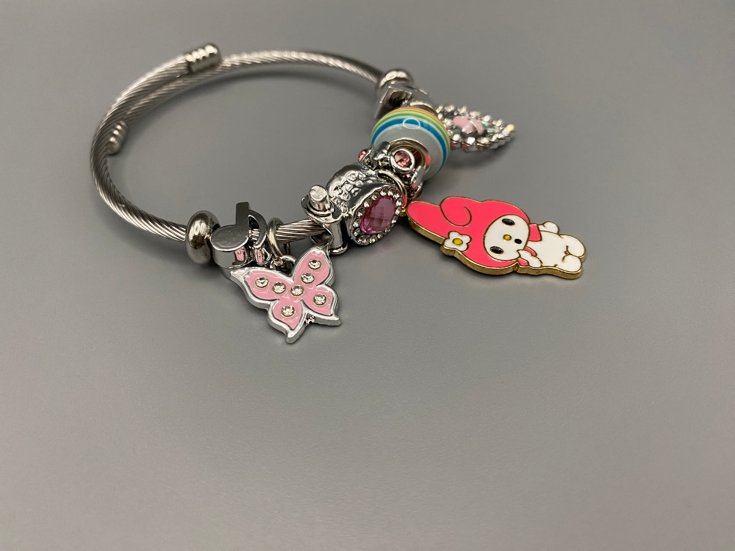 “Cartoon Character Bracelet in Dark Pink with a playful and stylish design, made from durable stainless steel, alloy charms, crystals, and glass beads. Adjustable 6cm diameter for a comfortable fit.”