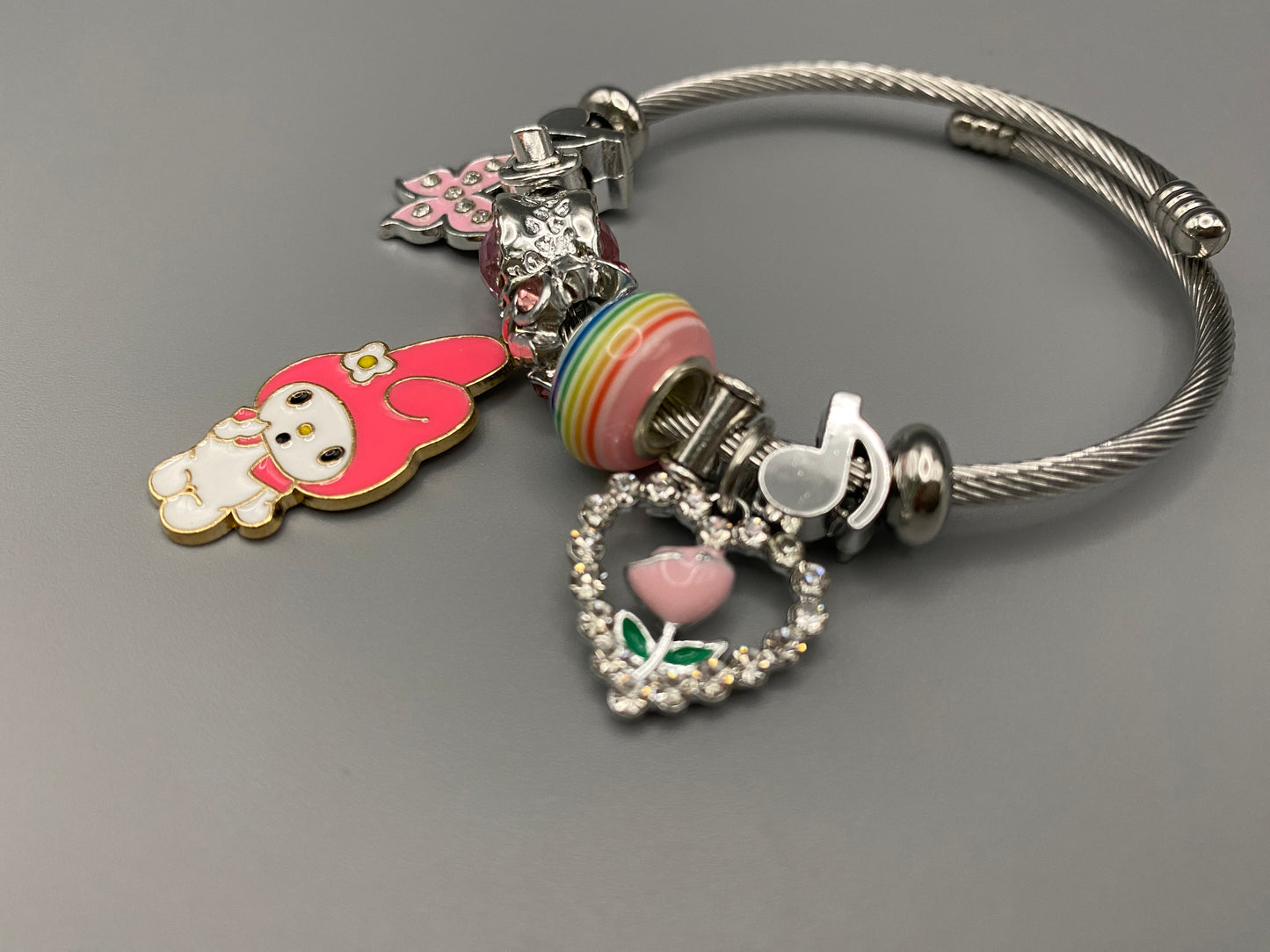 “Cartoon Character Bracelet in Dark Pink with a playful and stylish design, made from durable stainless steel, alloy charms, crystals, and glass beads. Adjustable 6cm diameter for a comfortable fit.”