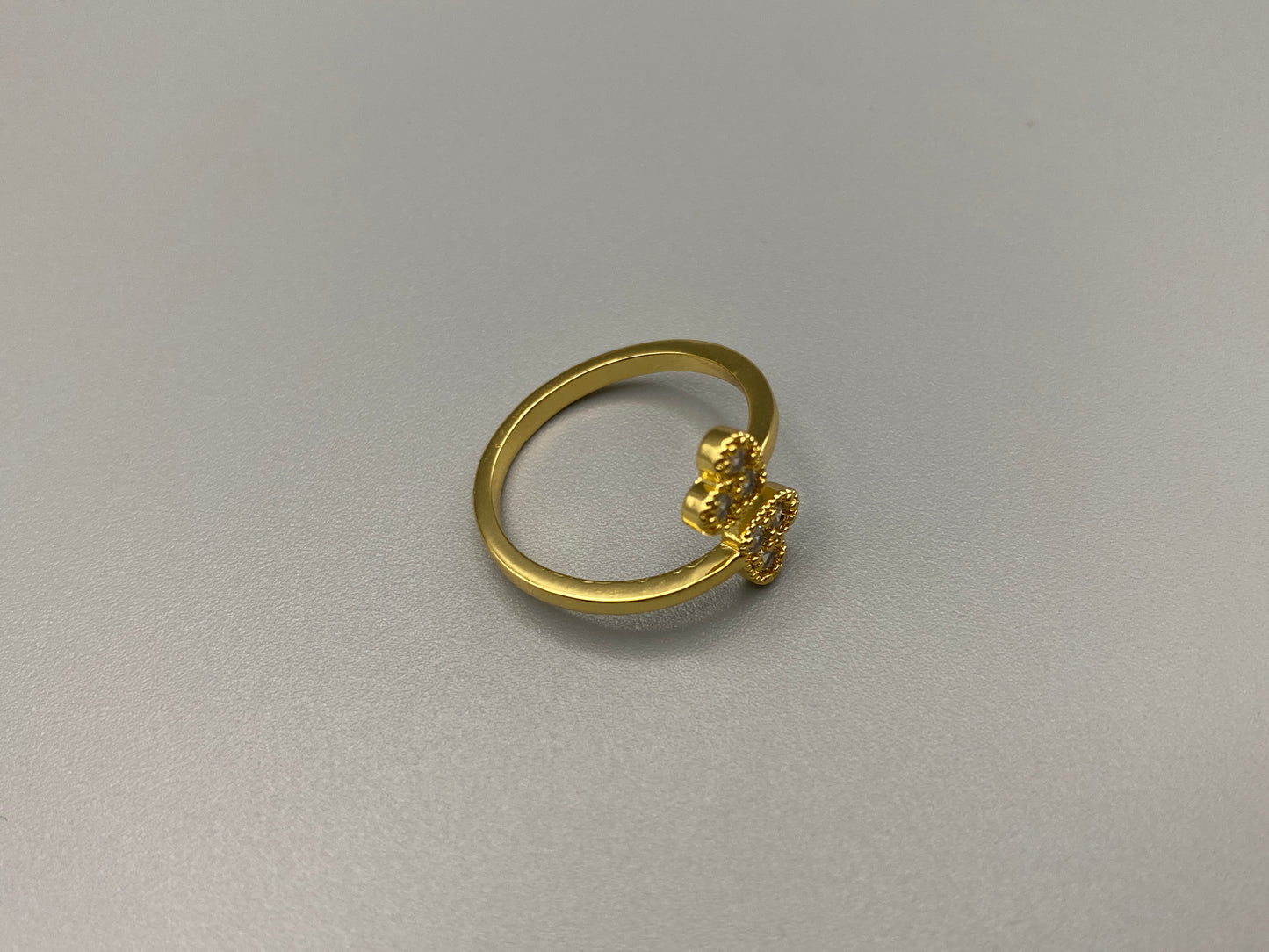 Dove Double Heart Adjustable Ring Gold: This beautiful ring features a double heart design, each adorned with sparkling zirconia stones. The elegant design, combined with 18k gold plating, creates a romantic and timeless look. The ring is non-tarnish, waterproof, nickel-free, and non-fading, ensuring it maintains its shine and is safe for sensitive skin. The adjustable size provides a comfortable fit for various finger sizes.