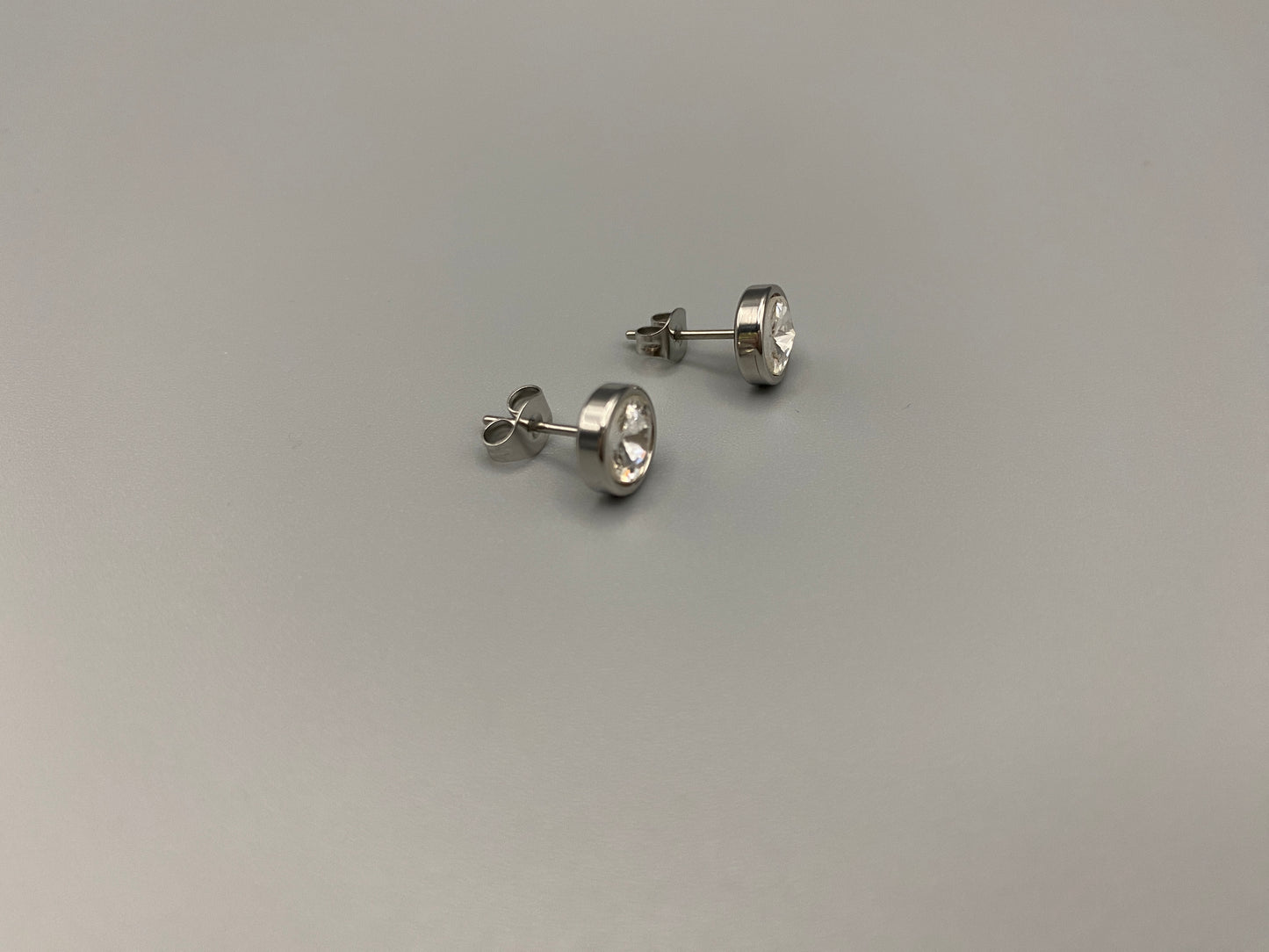 Elara Stud Earrings Silver Chic stud earrings featuring dazzling AAA Zircon stones set in high-quality 304 stainless steel, silver plated, with an 8mm size and micro insert inlay technology. These earrings offer a perfect blend of elegance and durability.