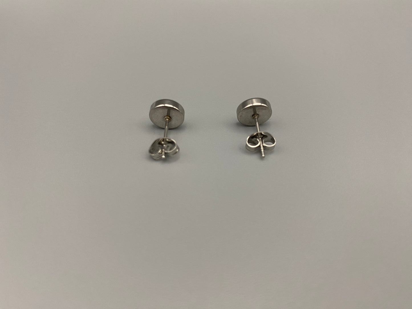 Elara Stud Earrings Silver Chic stud earrings featuring dazzling AAA Zircon stones set in high-quality 304 stainless steel, silver plated, with an 8mm size and micro insert inlay technology. These earrings offer a perfect blend of elegance and durability.