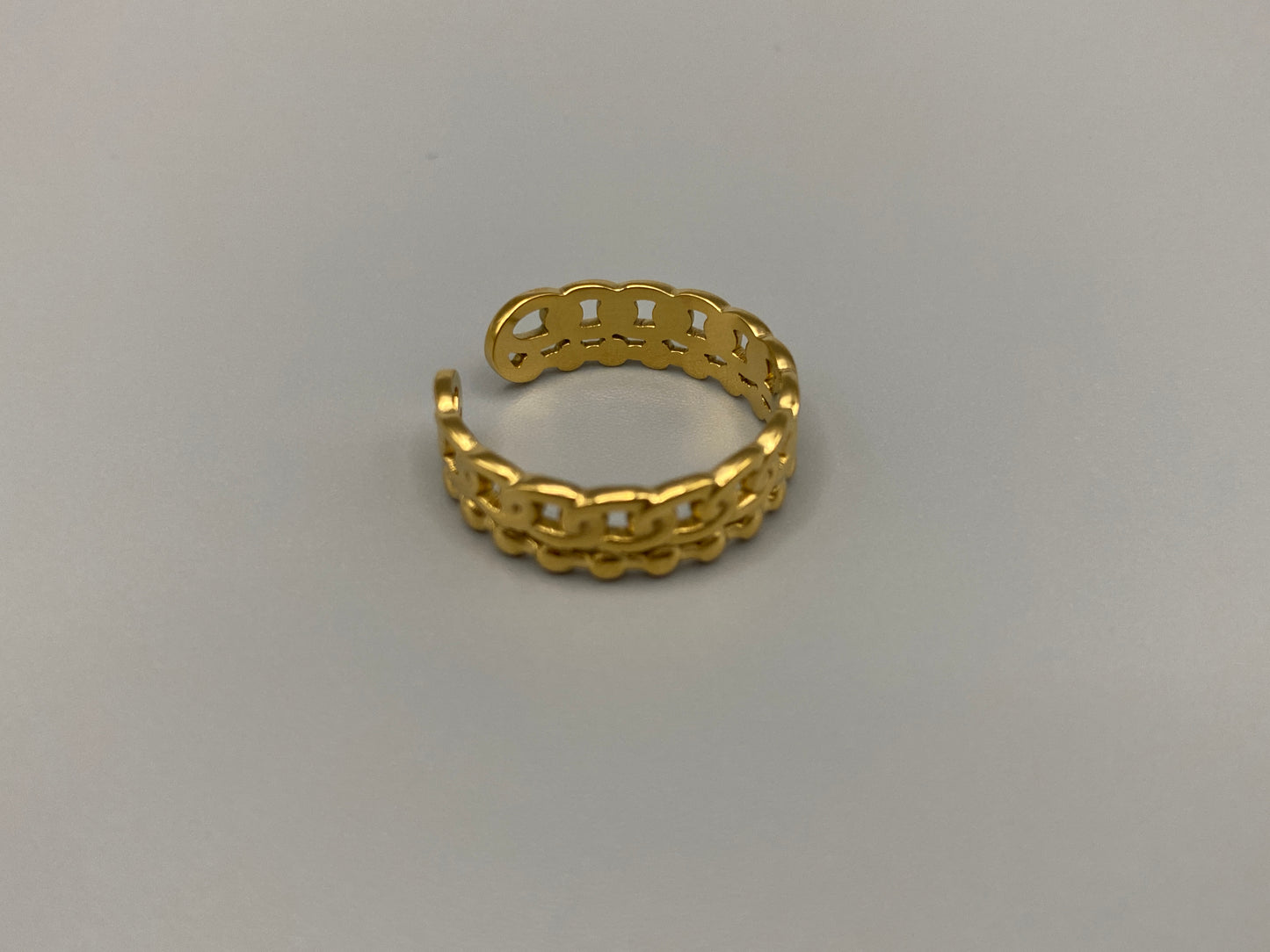This unique ring features a dual chain design, creating an open and airy look that is both modern and elegant. The open hollow dual chain design adds a contemporary touch, while the gold plating ensures a luxurious finish. Made from durable titanium and stainless steel, it offers strength and longevity. Available in size 6, it provides a comfortable fit. Perfect for any occasion, this versatile accessory complements both casual and formal outfits.