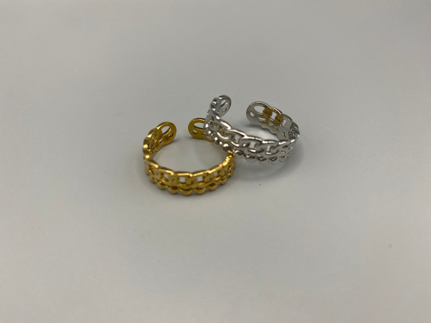 This unique ring features a dual chain design, creating an open and airy look that is both modern and elegant. The open hollow dual chain design adds a contemporary touch, while the gold plating ensures a luxurious finish. Made from durable titanium and stainless steel, it offers strength and longevity. Available in size 6, it provides a comfortable fit. Perfect for any occasion, this versatile accessory complements both casual and formal outfits.