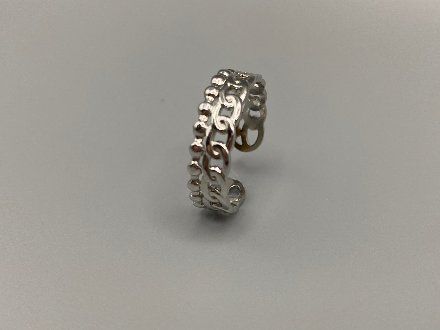 This unique ring features a dual chain design, creating an open and airy look that is both modern and elegant. The open hollow dual chain design adds a contemporary touch, while the plating ensures a luxurious finish. Made from durable titanium and stainless steel, it offers strength and longevity. Available in size 6, it provides a comfortable fit. Perfect for any occasion, this versatile accessory complements both casual and formal outfits.