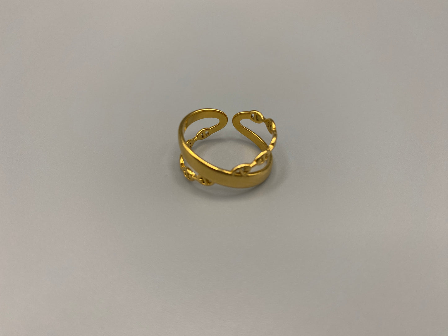 Francesca Ring Gold: A stunning piece of jewellery that combines elegance with modern design. Crafted from high-quality stainless steel and plated with gold, it features a double-layer ‘D’ shape and an adjustable band. This ring is nickel-free and lead-free, ensuring safety for sensitive skin. The channel setting adds a touch of sophistication. Perfect for gifts, anniversaries, parties, and more, the adjustable band ensures a perfect fit for any finger size, making it a versatile addition to any jewellery c