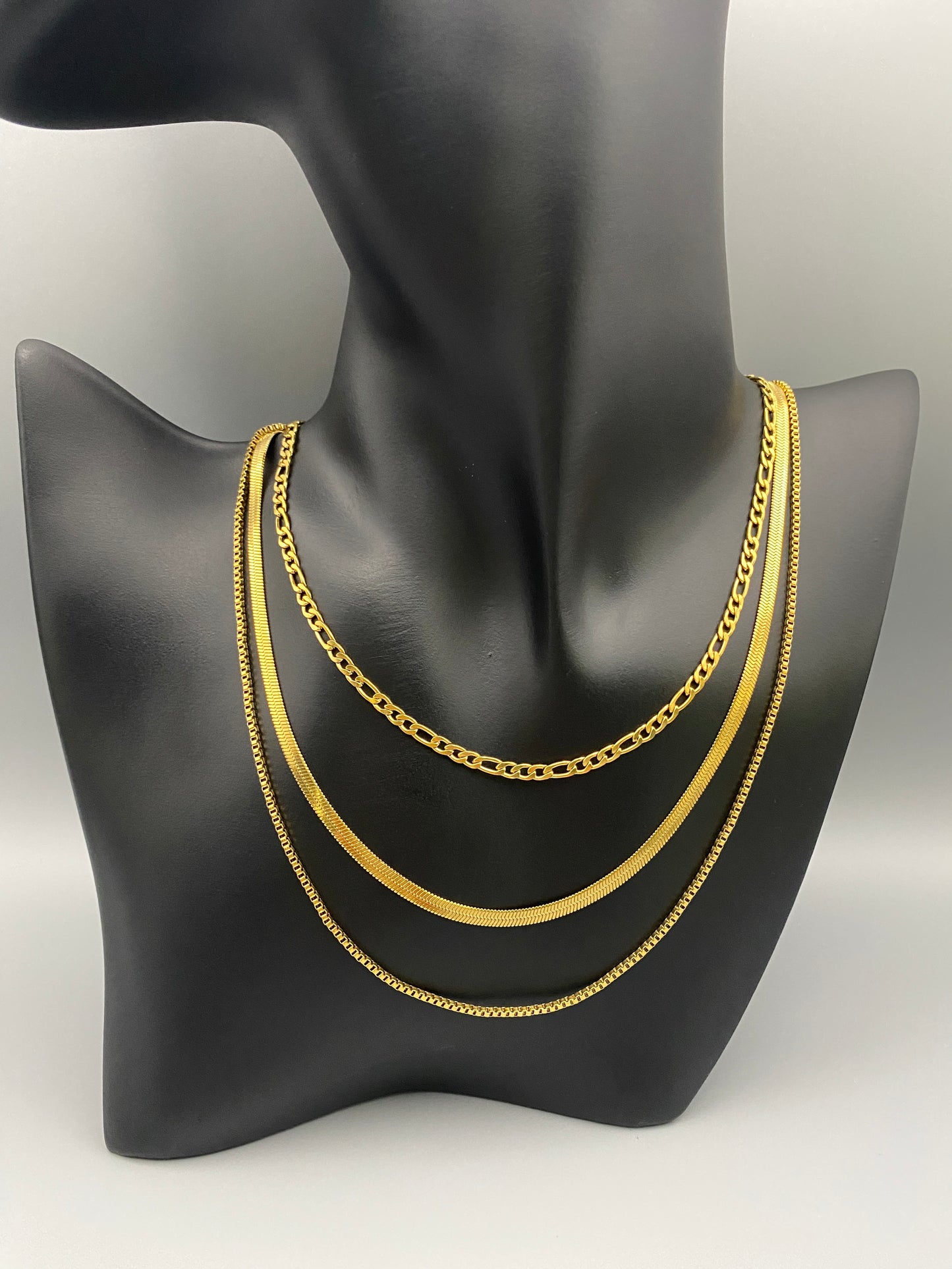 Gina Three Layered Gold Chain Necklace. Three delicate chains layered for a sophisticated look. 18k gold plated, PVD plated for durability. Stainless steel, corrosion-resistant. Adjustable length: 40 cm + 5 cm extender. Versatile for casual and formal wear.