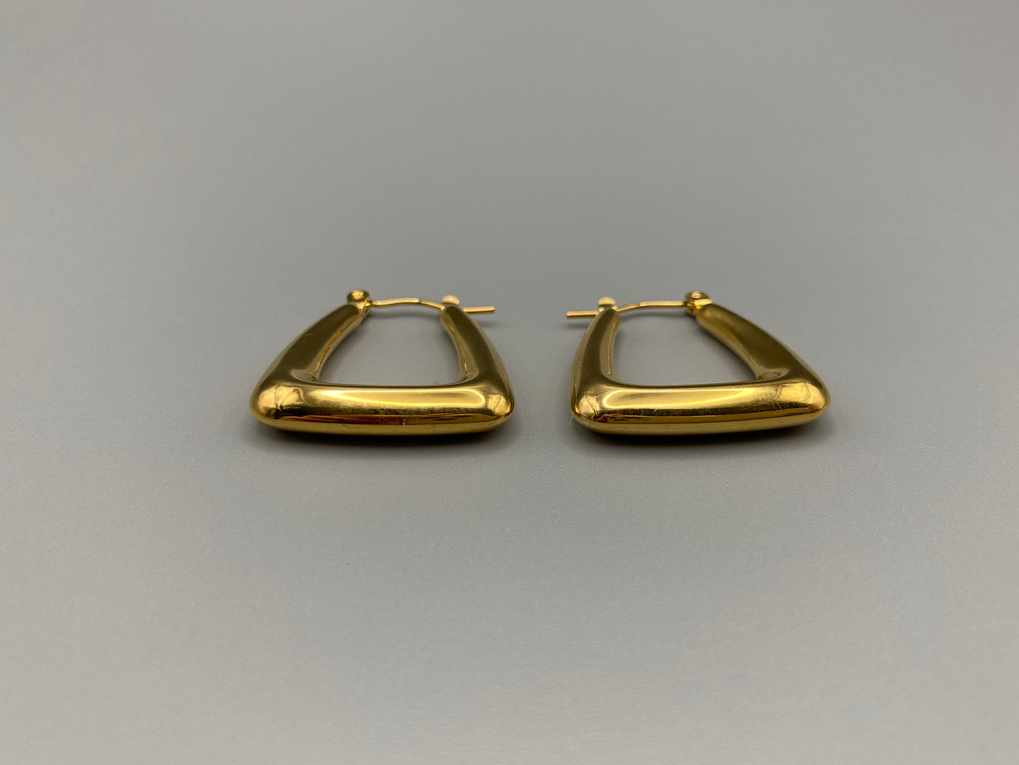 Harmony Gold Earrings made from stainless steel with PVD 18k gold and titanium plating. Hypoallergenic, lead and nickel-free, perfect for sensitive skin. Featuring a trendy geometric shape and tarnish-free colour retention, these earrings blend elegance and durability.