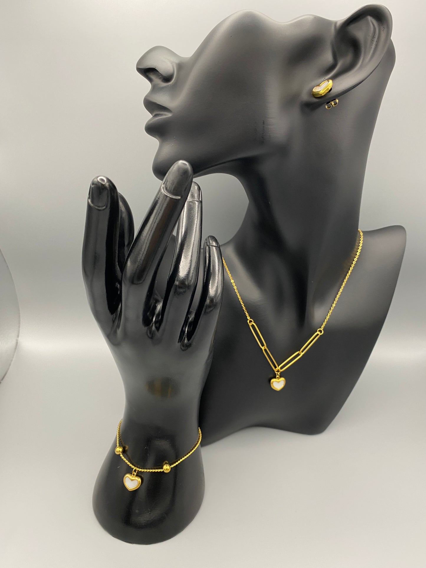 Versatile and elegant Helena Heart Earrings featuring a white shell heart pendant, crafted from high-quality titanium steel and plated with 18k gold. These earrings are waterproof, tarnish-free, and environmentally friendly, offering a trendy style and superior craftsmanship.