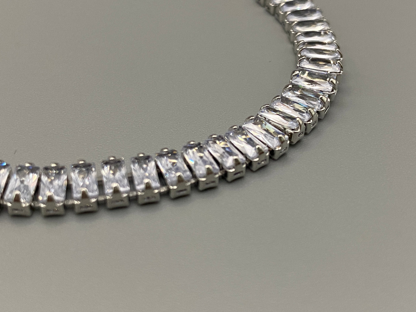 “Isdis Bracelet with a luxurious hip hop design, made from high-quality copper and adorned with sparkling zirconia stones. Features an adjustable closure with pull strings.”