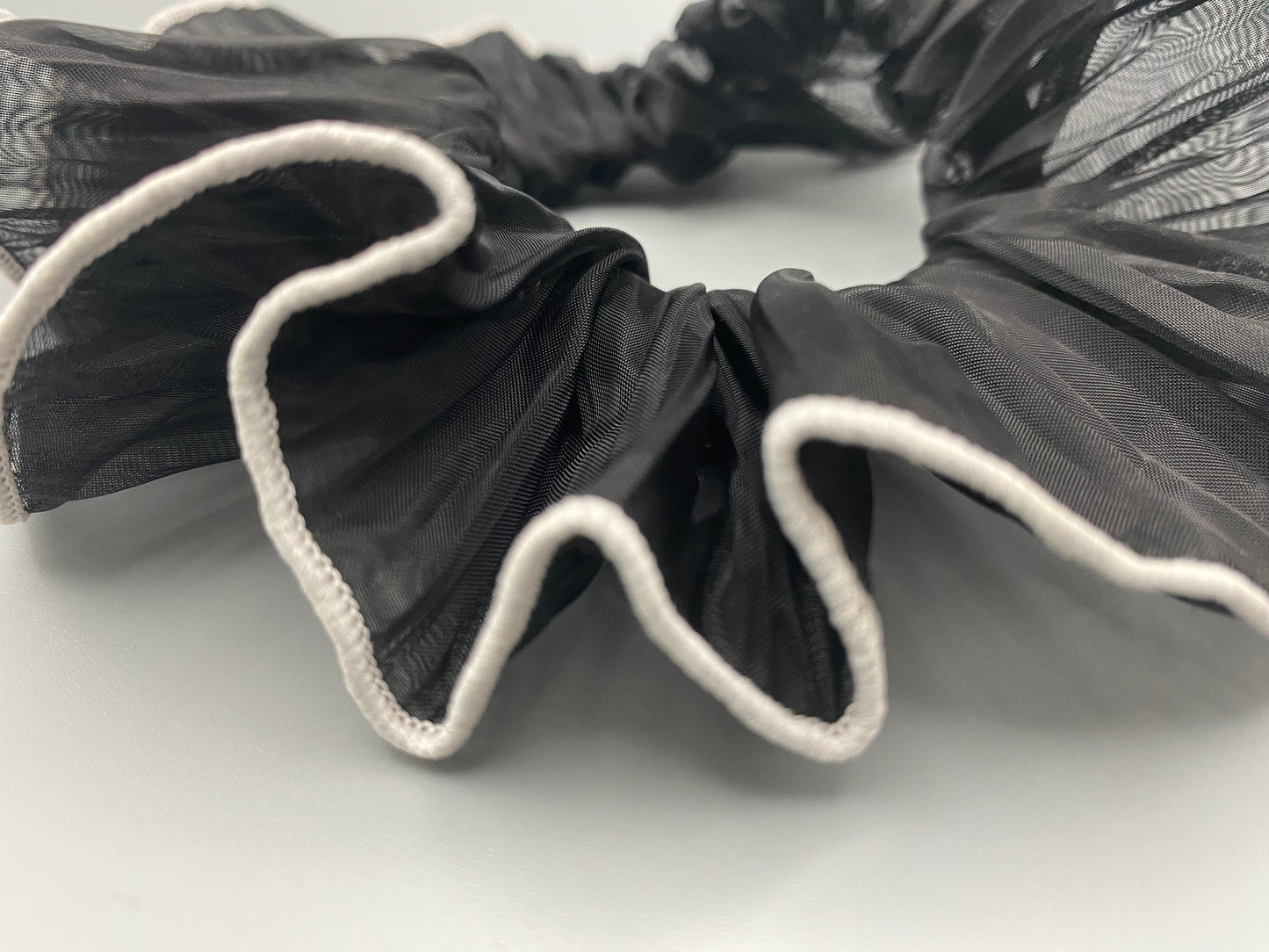 “Juliette Black Colour French Style Scrunchie, a chic and elegant hair accessory perfect for various hairstyles. Made from high-quality material for durability and style.”