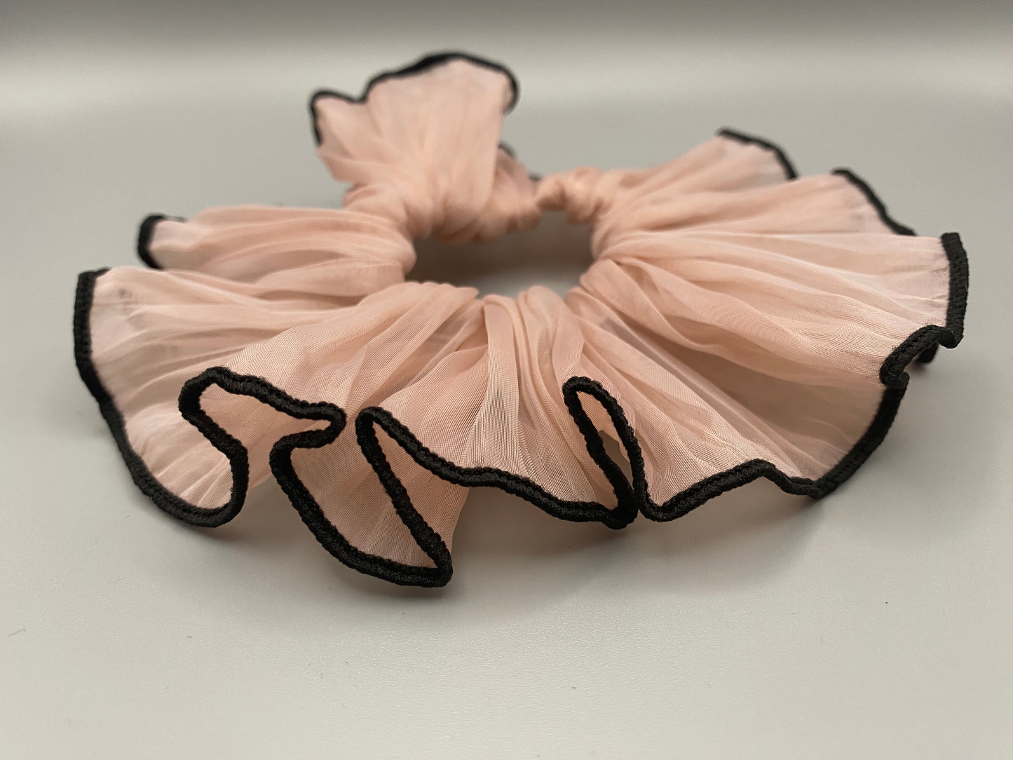 “Juliette Pink Colour French Style Scrunchie, a chic and elegant hair accessory perfect for various hairstyles. Made from high-quality material for durability and style.”