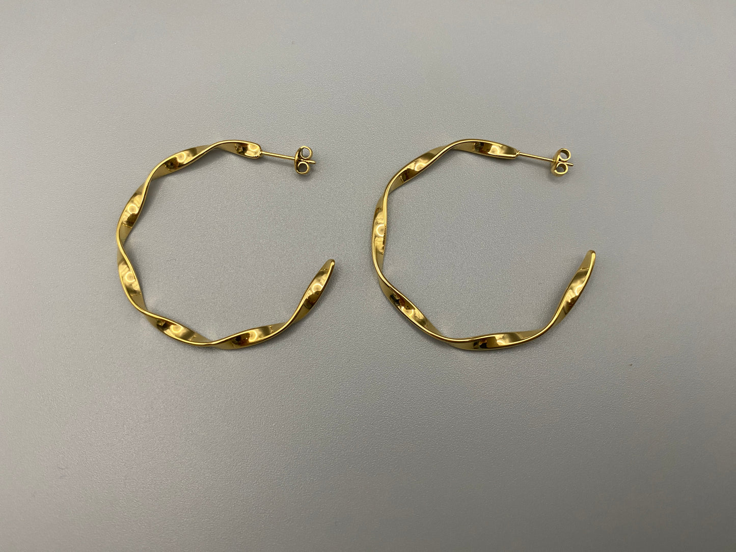 “Leanne C Shape Earrings Gold: Fashion-forward twisted wire earrings with an irregular C-shaped design, crafted from high-quality stainless steel and plated with luxurious 18K gold. Perfect for any occasion.”