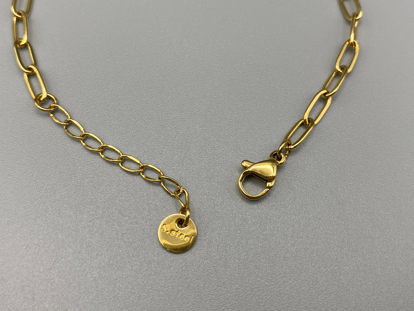The Nexa Chain Link Bracelet is made of premium gold stainless steel with titanium steel construction and features a modern chain link design with gold PVD plating. It measures 17 cm with a 3 cm adjustment for a sleek, durable, and stylish look." elegant look."