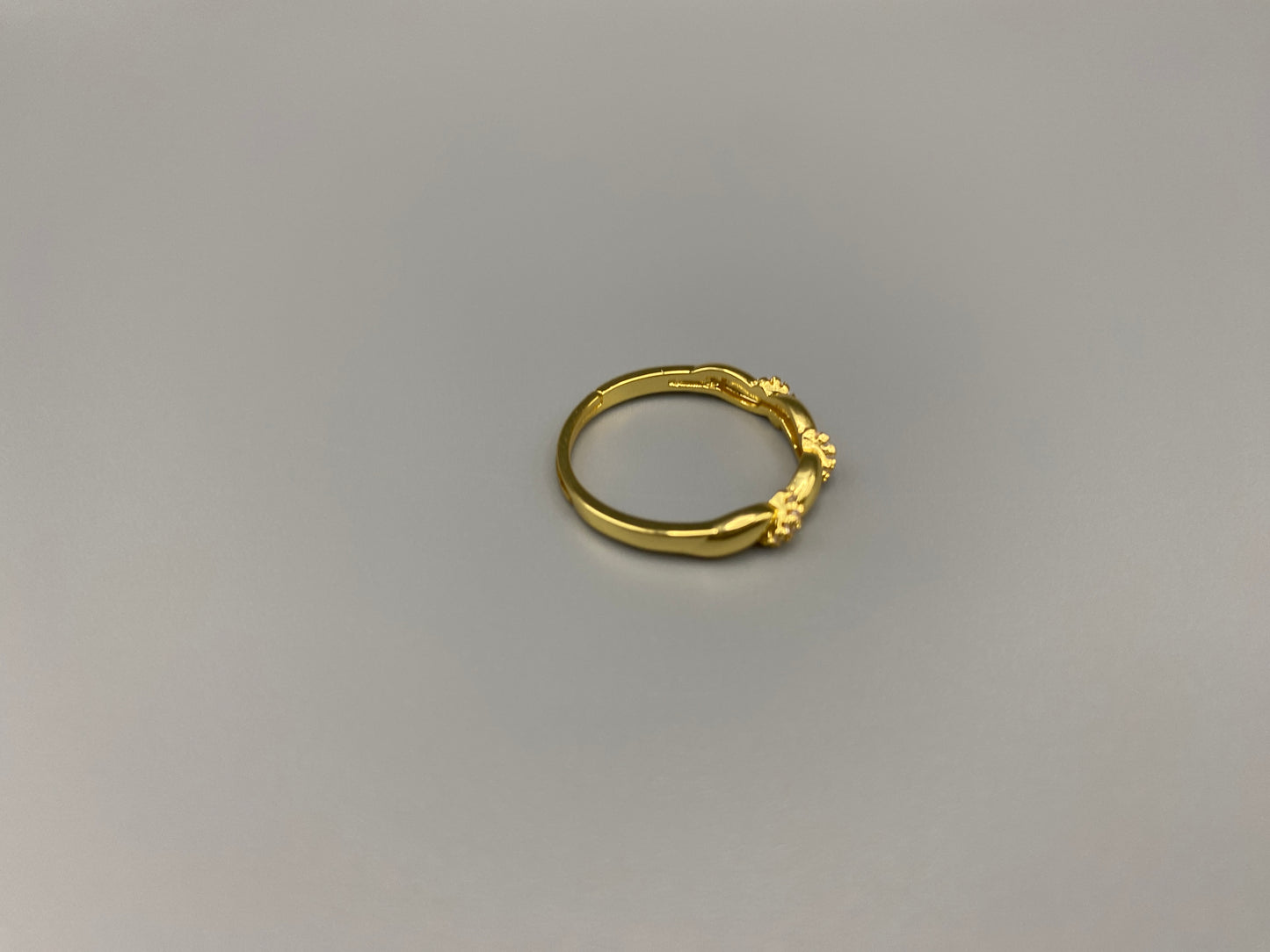 Olivia Adjustable Ring Gold: This exquisite piece is 18k gold plated, offering a luxurious shine and timeless appeal. The ring is waterproof and non-tarnish, ensuring it maintains its beauty over time. Cubic zirconia accents add sparkle and elegance, while the adjustable design ensures a perfect fit for any finger size. Make a statement with this stunning piece that complements any look.