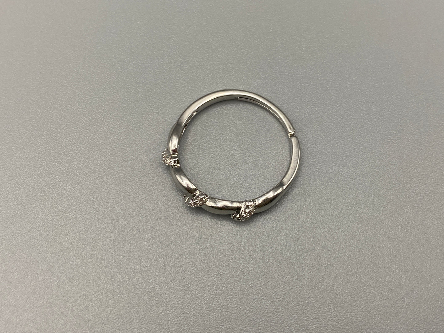 Olivia Adjustable Ring Silver: This exquisite piece plated, offering a luxurious shine and timeless appeal. The ring is waterproof and non-tarnish, ensuring it maintains its beauty over time. Cubic zirconia accents add sparkle and elegance, while the adjustable design ensures a perfect fit for any finger size. Make a statement with this stunning piece that complements any look.
