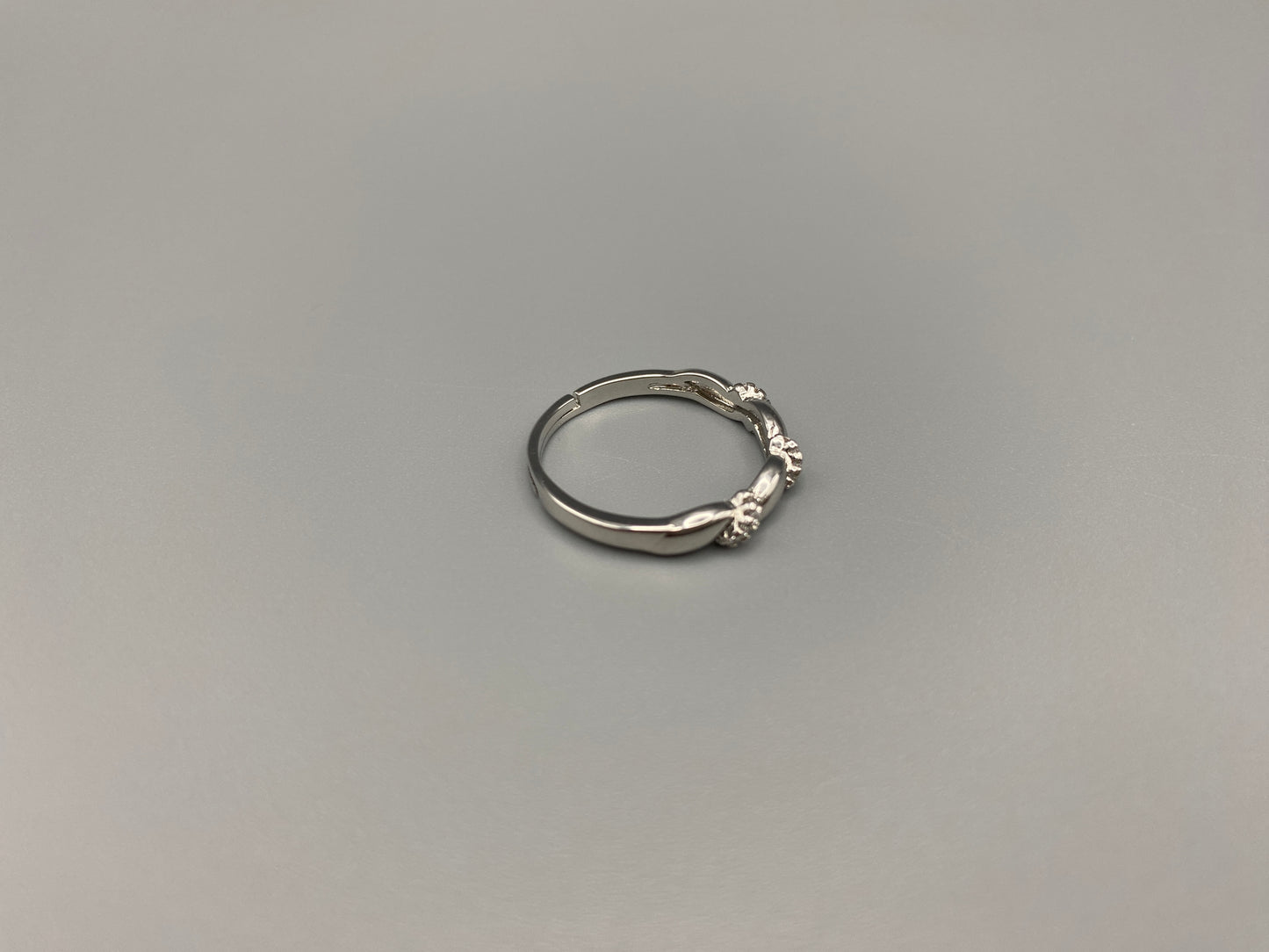 Olivia Adjustable Ring Silver: This exquisite piece plated, offering a luxurious shine and timeless appeal. The ring is waterproof and non-tarnish, ensuring it maintains its beauty over time. Cubic zirconia accents add sparkle and elegance, while the adjustable design ensures a perfect fit for any finger size. Make a statement with this stunning piece that complements any look.