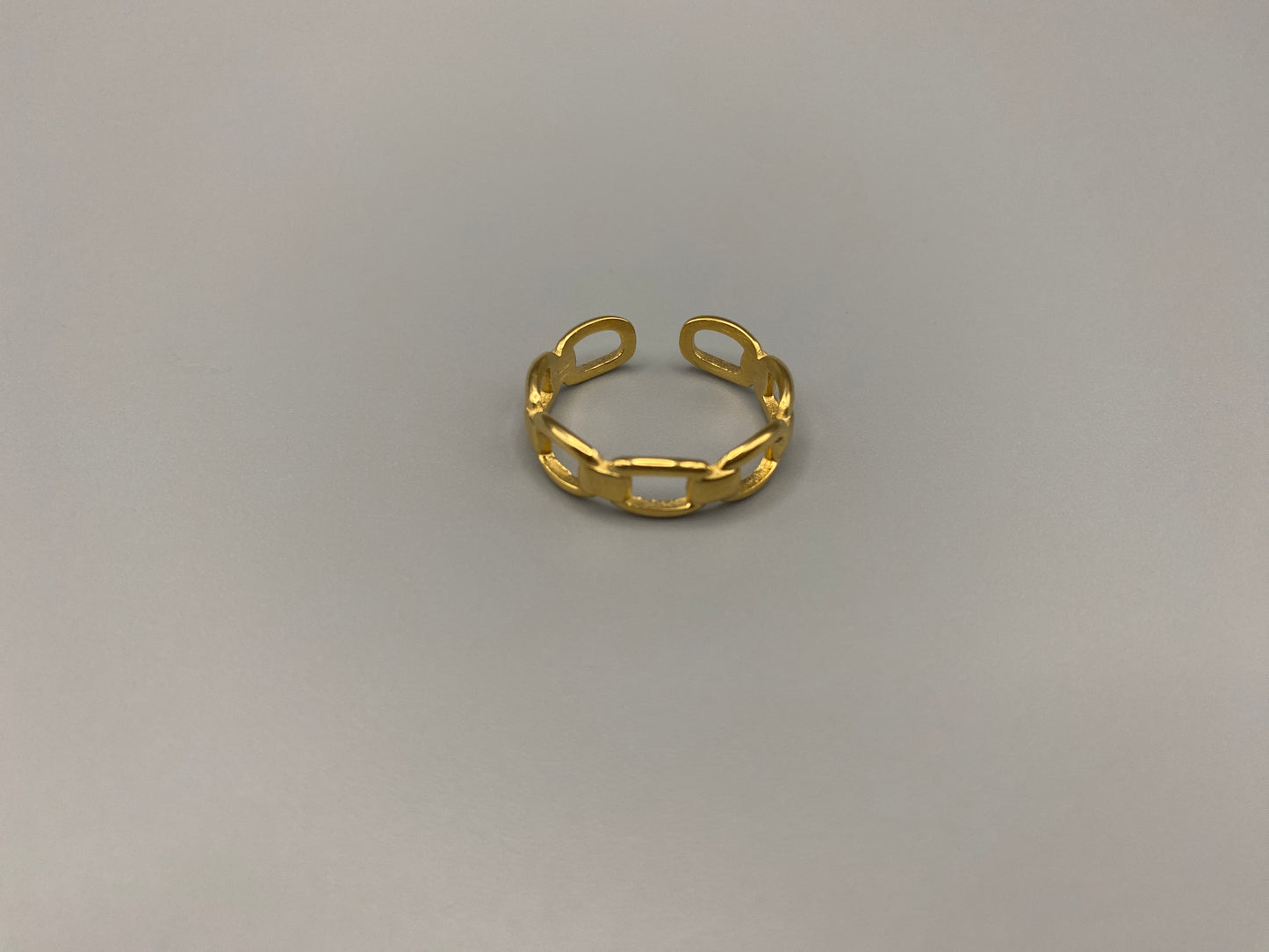 Phoebe Gold Ring: Discover the Phoebe Gold Ring, a fashionable and versatile piece perfect for any occasion. This 18K gold-plated stainless steel ring features a hollow geometric link chain design. It is resizable to size 6, making it a trendy and adaptable accessory. Ideal for daily wear or special events like anniversaries and parties, this ring is both nickel-free and lead-free, ensuring it is safe for all skin types.