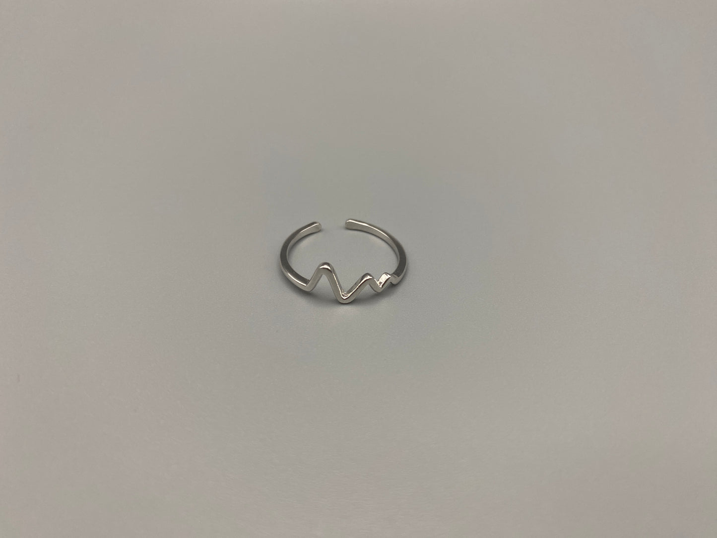 Pulse Ring Silver: This adjustable ring features a heartbeat pattern, crafted from high-quality 925 sterling silver and plated with a non-tarnish, waterproof finish. It is designed to be anti-allergy, making it perfect for any occasion, whether it’s an anniversary, engagement, wedding, or party.