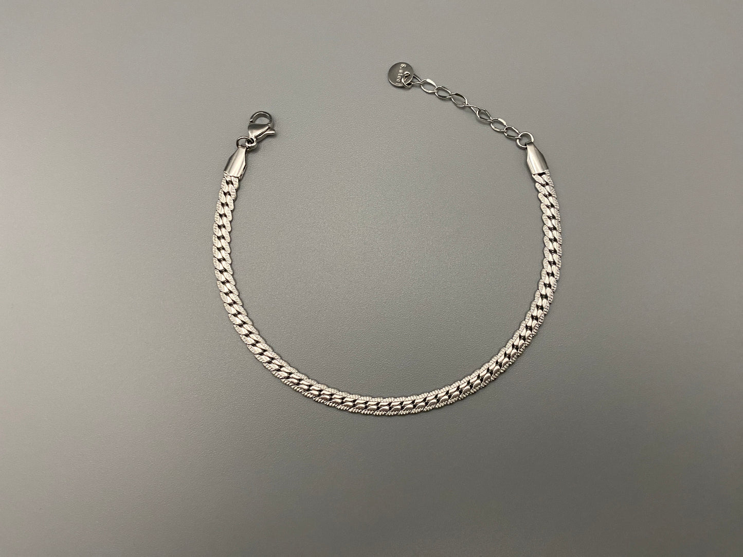 “Seraphina Bracelet in Silver with a unique snake-linked design, featuring luxurious Silver plating. Adjustable length of 17 cm with a 3 cm extension. Durable construction ensures long-lasting wear and tarnish resistance.”