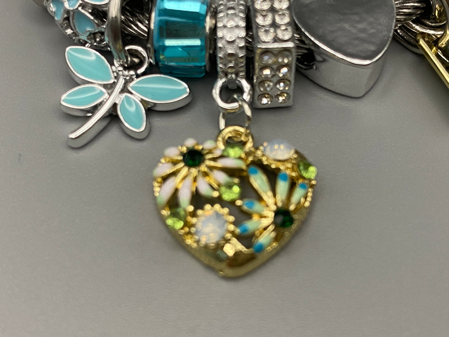 “Stellar Charm Bracelet in blue with playful charms including a heart, butterfly, and cube, crafted from high-quality stainless steel. Suitable for both women and kids, making it a perfect gift for any occasion.”