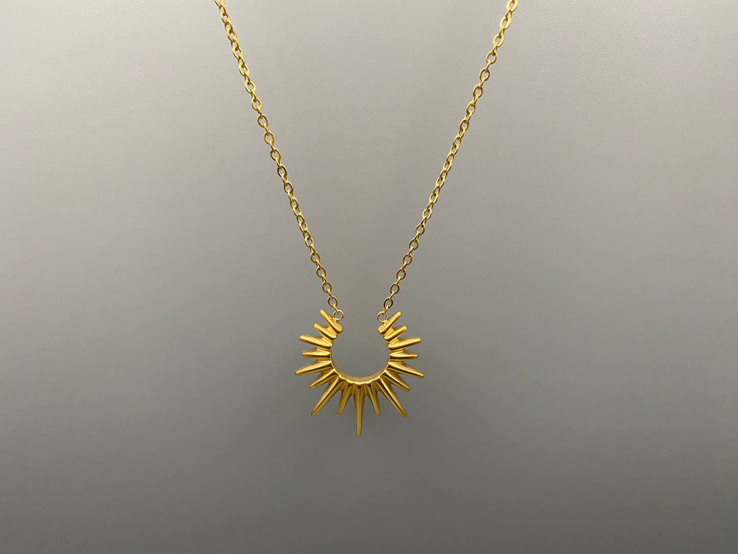 Sunburst Pendant Necklace Gold. Radiant and elegant. 18k gold plated pendant. Waterproof, non-tarnish, non-fade. Length: 45 cm + 5 cm extender. Stainless steel construction. Unique sunburst design.