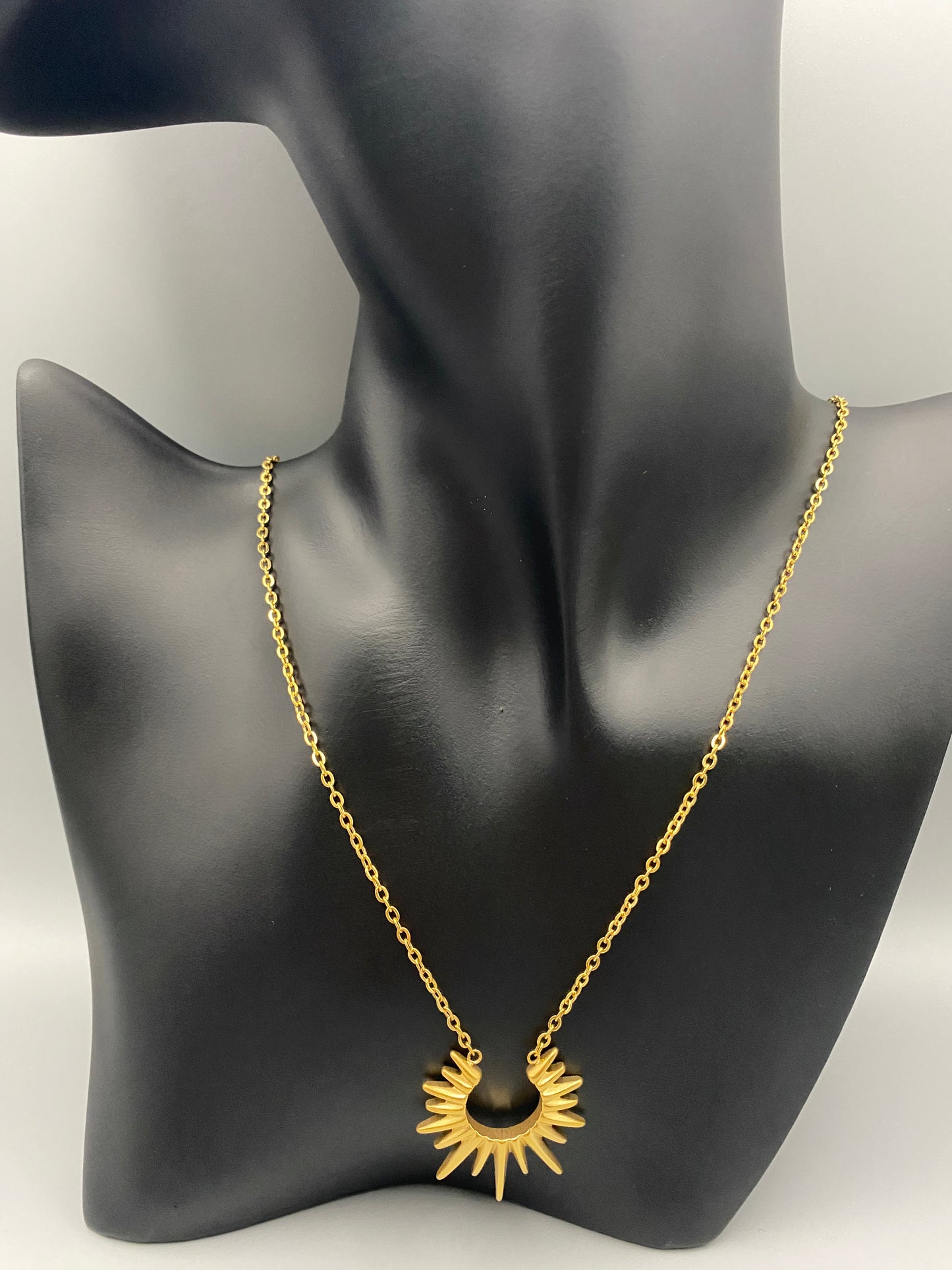 Sunburst Pendant Necklace Gold. Radiant and elegant. 18k gold plated pendant. Waterproof, non-tarnish, non-fade. Length: 45 cm + 5 cm extender. Stainless steel construction. Unique sunburst design.