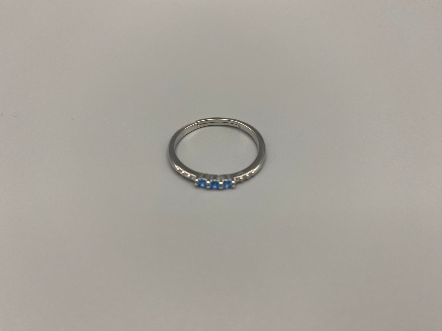 Tanvi Blue Ring: This stunning piece features alternating brilliant blue and clear cubic zirconia stones, set in a sleek silver-plated band. The adjustable fit ensures comfort for any finger size. The ring is non-tarnish and waterproof, maintaining its shine over time. Perfect for everyday wear, the Tanvi ring is your go-to accessory for timeless beauty.