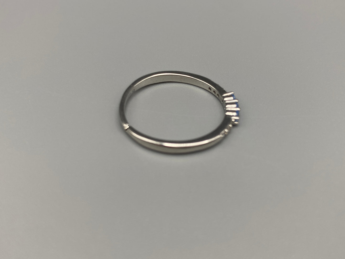 Tanvi Blue Ring: This stunning piece features alternating brilliant blue and clear cubic zirconia stones, set in a sleek silver-plated band. The adjustable fit ensures comfort for any finger size. The ring is non-tarnish and waterproof, maintaining its shine over time. Perfect for everyday wear, the Tanvi ring is your go-to accessory for timeless beauty.