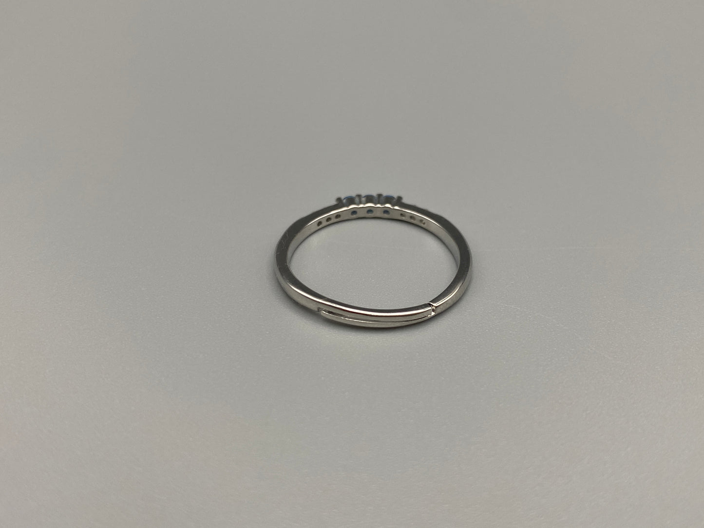 Tanvi Blue Ring: This stunning piece features alternating brilliant blue and clear cubic zirconia stones, set in a sleek silver-plated band. The adjustable fit ensures comfort for any finger size. The ring is non-tarnish and waterproof, maintaining its shine over time. Perfect for everyday wear, the Tanvi ring is your go-to accessory for timeless beauty.