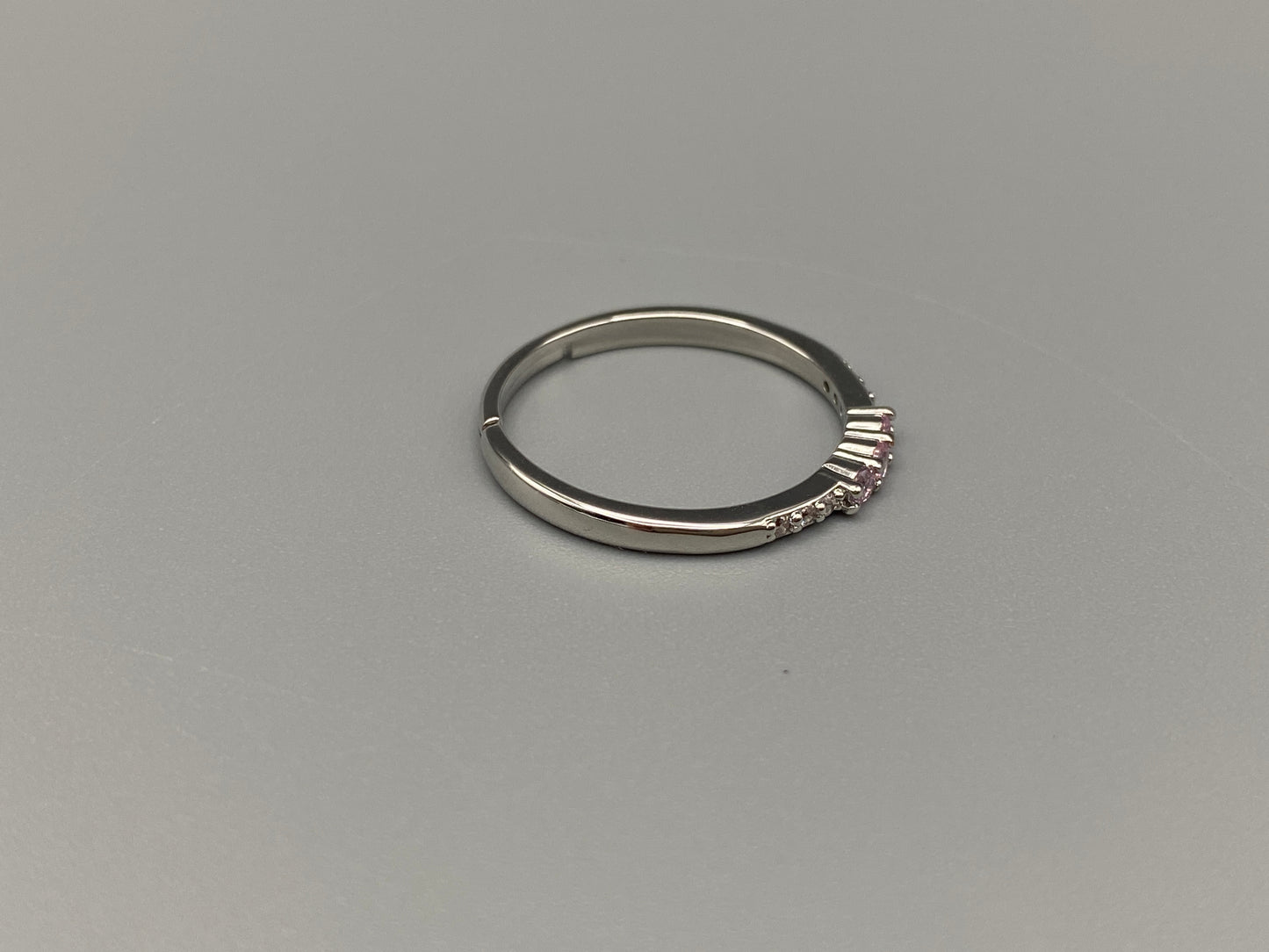 anvi Pink Ring: This stunning piece features alternating brilliant blue and clear cubic zirconia stones, set in a sleek silver-plated band. The adjustable fit ensures comfort for any finger size. The ring is non-tarnish and waterproof, maintaining its shine over time. Perfect for everyday wear, the Tanvi ring is your go-to accessory for timeless beauty.