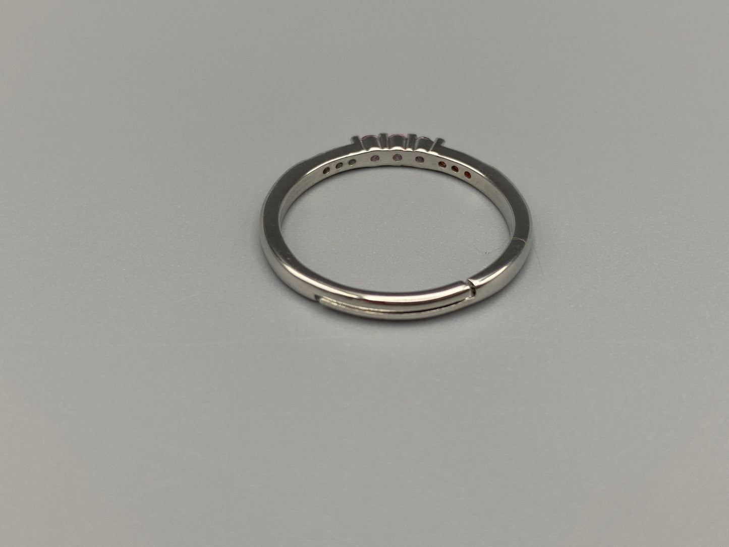 anvi Pink Ring: This stunning piece features alternating brilliant blue and clear cubic zirconia stones, set in a sleek silver-plated band. The adjustable fit ensures comfort for any finger size. The ring is non-tarnish and waterproof, maintaining its shine over time. Perfect for everyday wear, the Tanvi ring is your go-to accessory for timeless beauty.