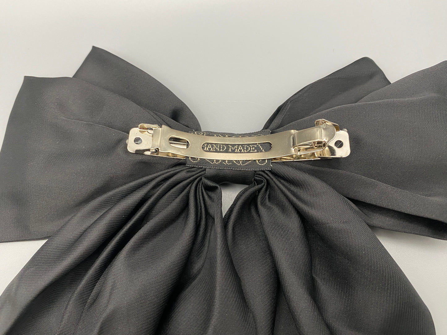 “The Amy Oversized Hair Bow in Black, crafted from high-quality satin with an oversized bowknot design. Features a minimalist spring clamp for a secure fit. Perfect for stylish updos, daily wear, and special occasions.”