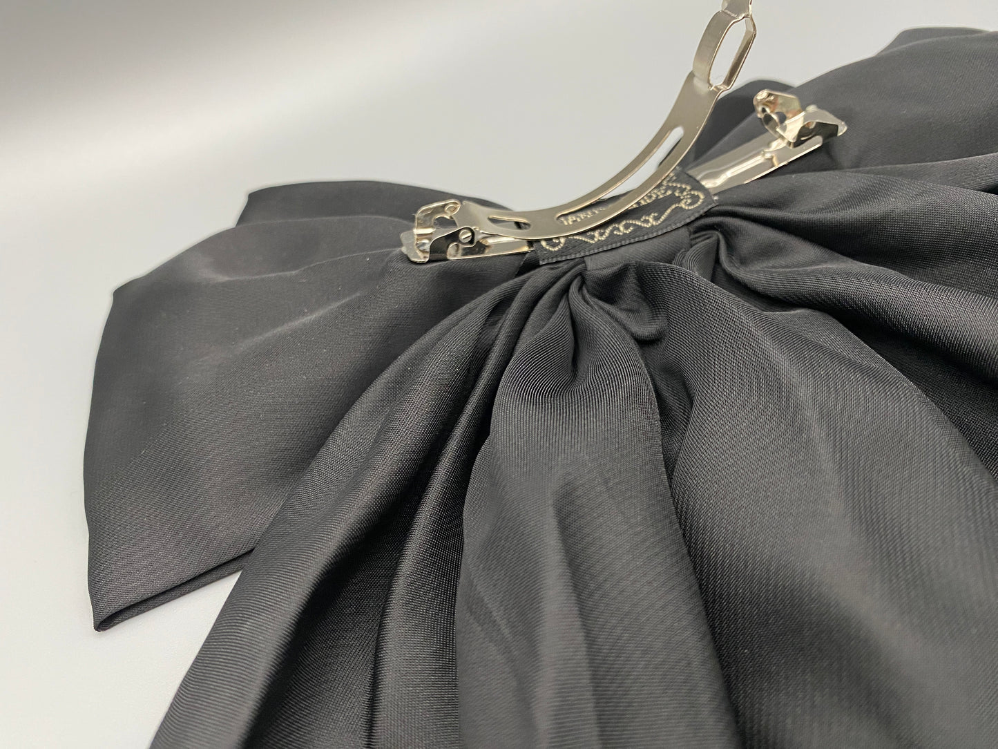 “The Amy Oversized Hair Bow in Black, crafted from high-quality satin with an oversized bowknot design. Features a minimalist spring clamp for a secure fit. Perfect for stylish updos, daily wear, and special occasions.”