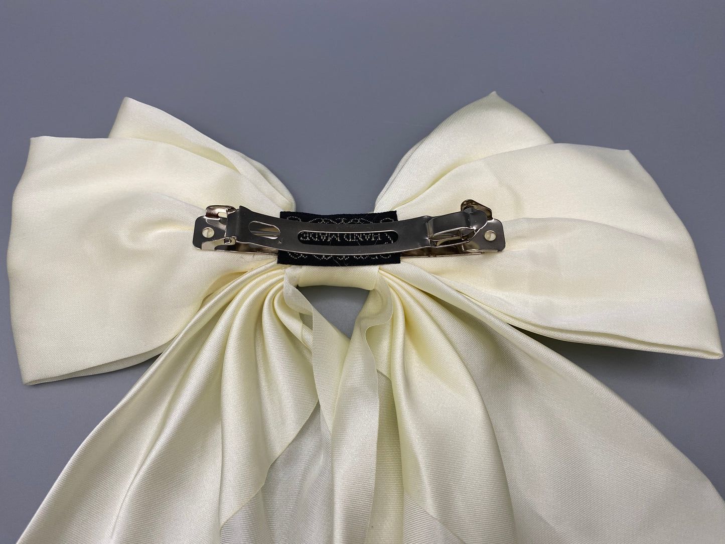 “The Amy Oversized Hair Bow in Cream, crafted from high-quality satin with an oversized bowknot design. Features a minimalist spring clamp for a secure fit. Perfect for stylish updos, daily wear, and special occasions.”